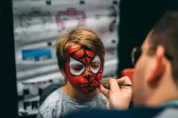 a photo of a boy face painting 