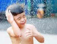 an photo of a boy showering after swim
