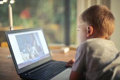a kid using laptop
