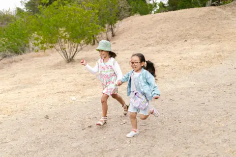an image of two kids running outdoors