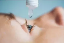 an image of a boy having some eye drops