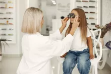 an image of a girl getting eye examined