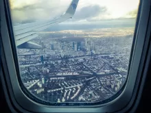 an image of looking out of a plane window and seeing the city