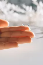an image of an contact lens on a finger