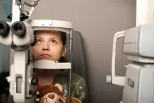 an image of an child having eye exam