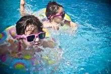 an image of kids swimming with sunglasses