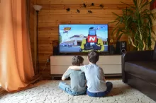 a photo of kids watching tv