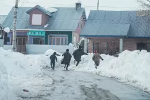 an image of kids running in snow