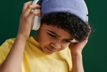 an image of a kid with beanie and head phone