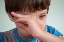 a photo of a child with eye discomfort